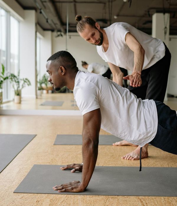 A focused man stretching, showing flexibility and concentration.